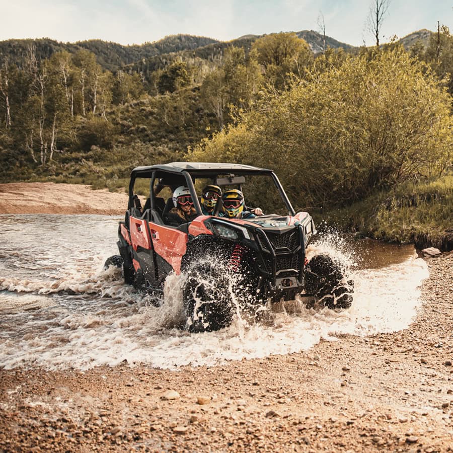 a family takes an ATV for a muddy drive through the Wasatch Mountains