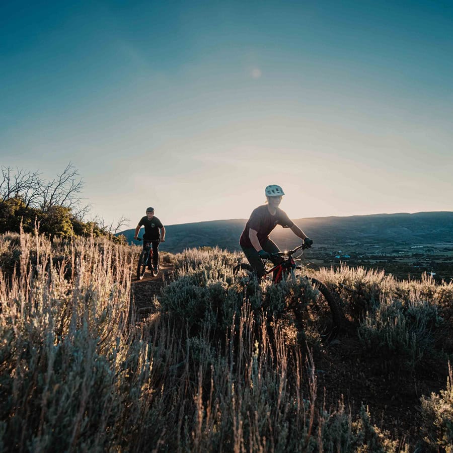 two mountain bikers navigate the paths through the Wasatch Mountains in Midway, Utah