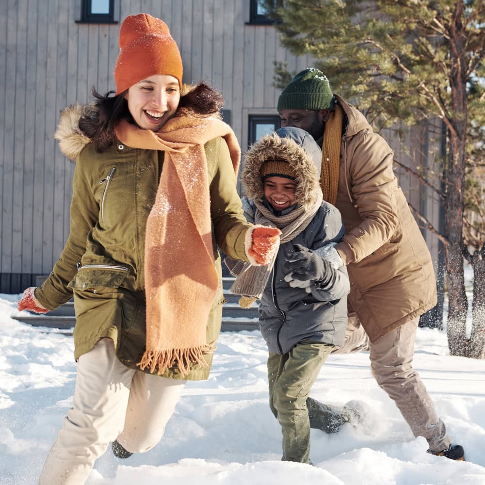 a family at play in the snow during winter in the scenic Wasatch Mountains