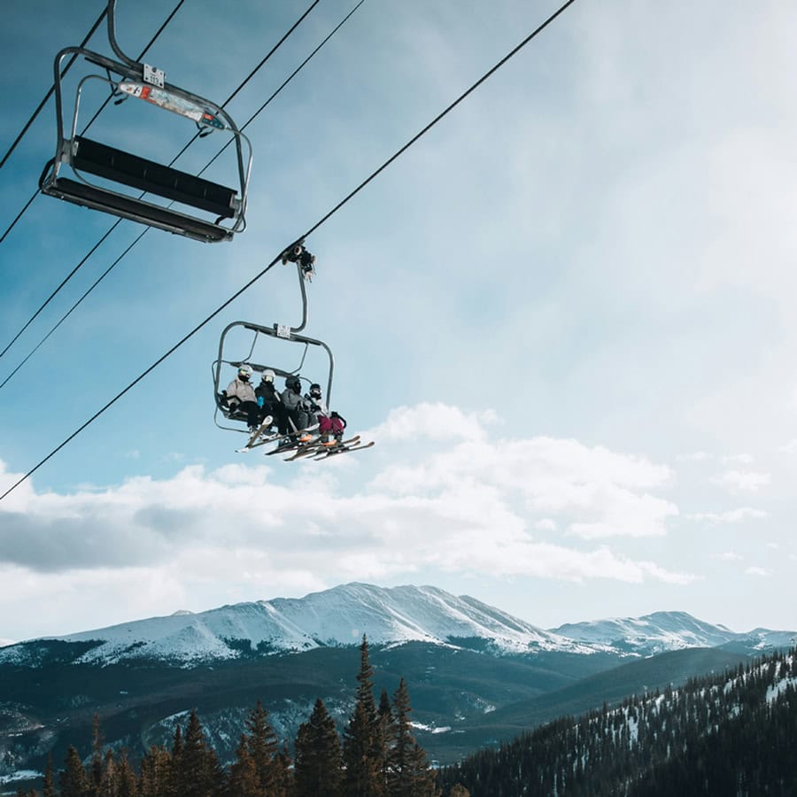 skiers take a lift to the top of the slopes just beyond the Homestead Residences in Midway, Utah