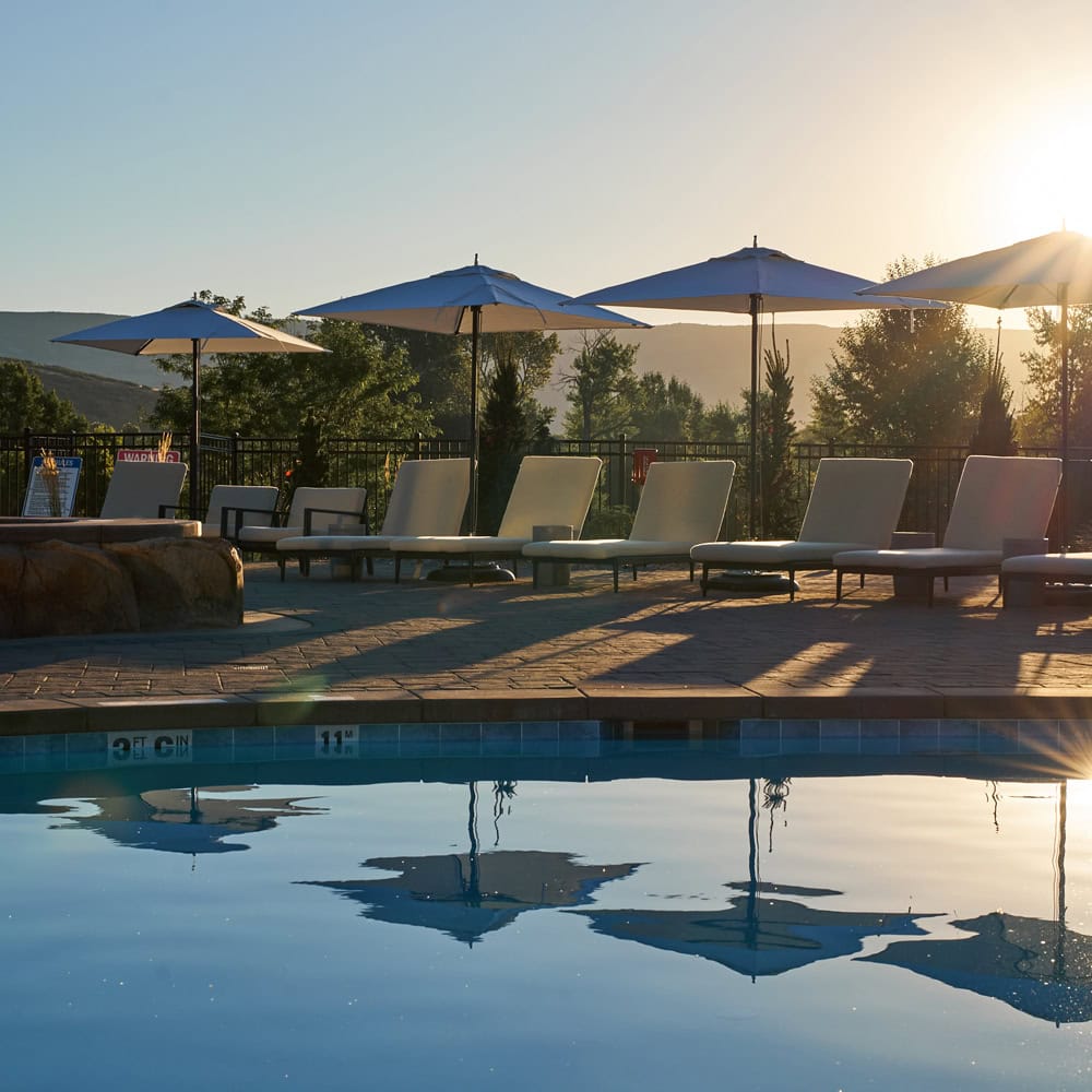sunlight reflects off the calm waters of the Homestead Residences pool
