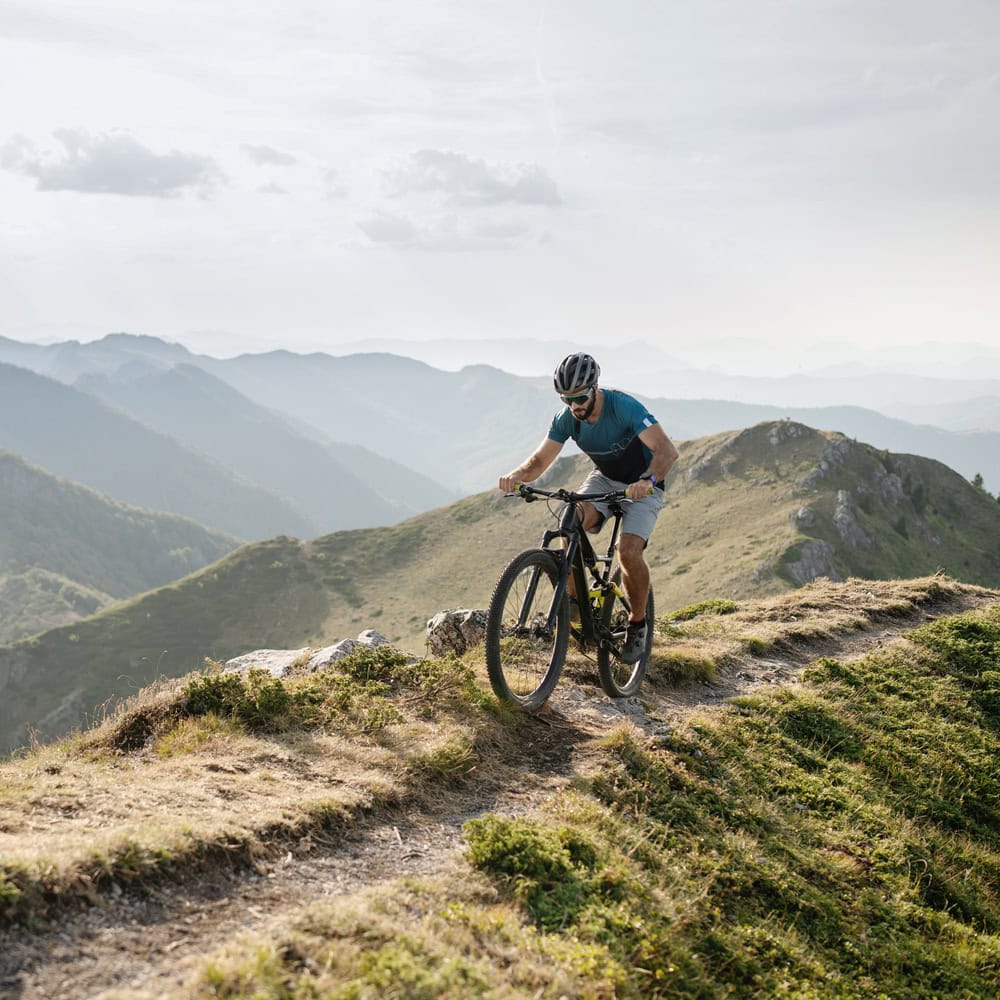 a man explores the Wasatch Mountains while off-road biking in Midway, Utah